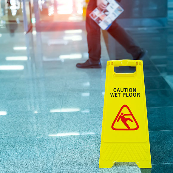 A wet floor sign covered by employers and public liability insurance with Insure 313.
