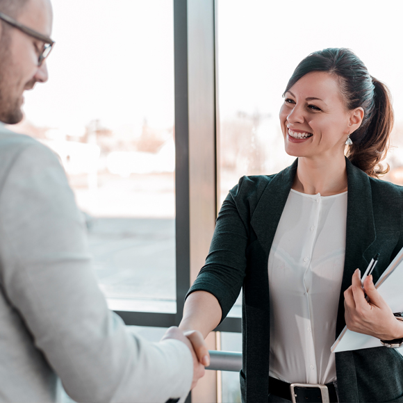 Business people shaking hands, a sign of good relations forged by Insure 313 insurance brokers.