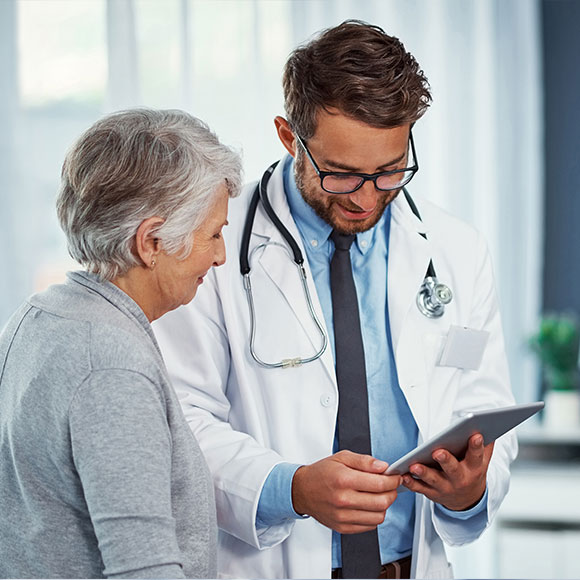 A doctor speaking with a patient who is insured under health insurance with Insure 313 insurance brokers.